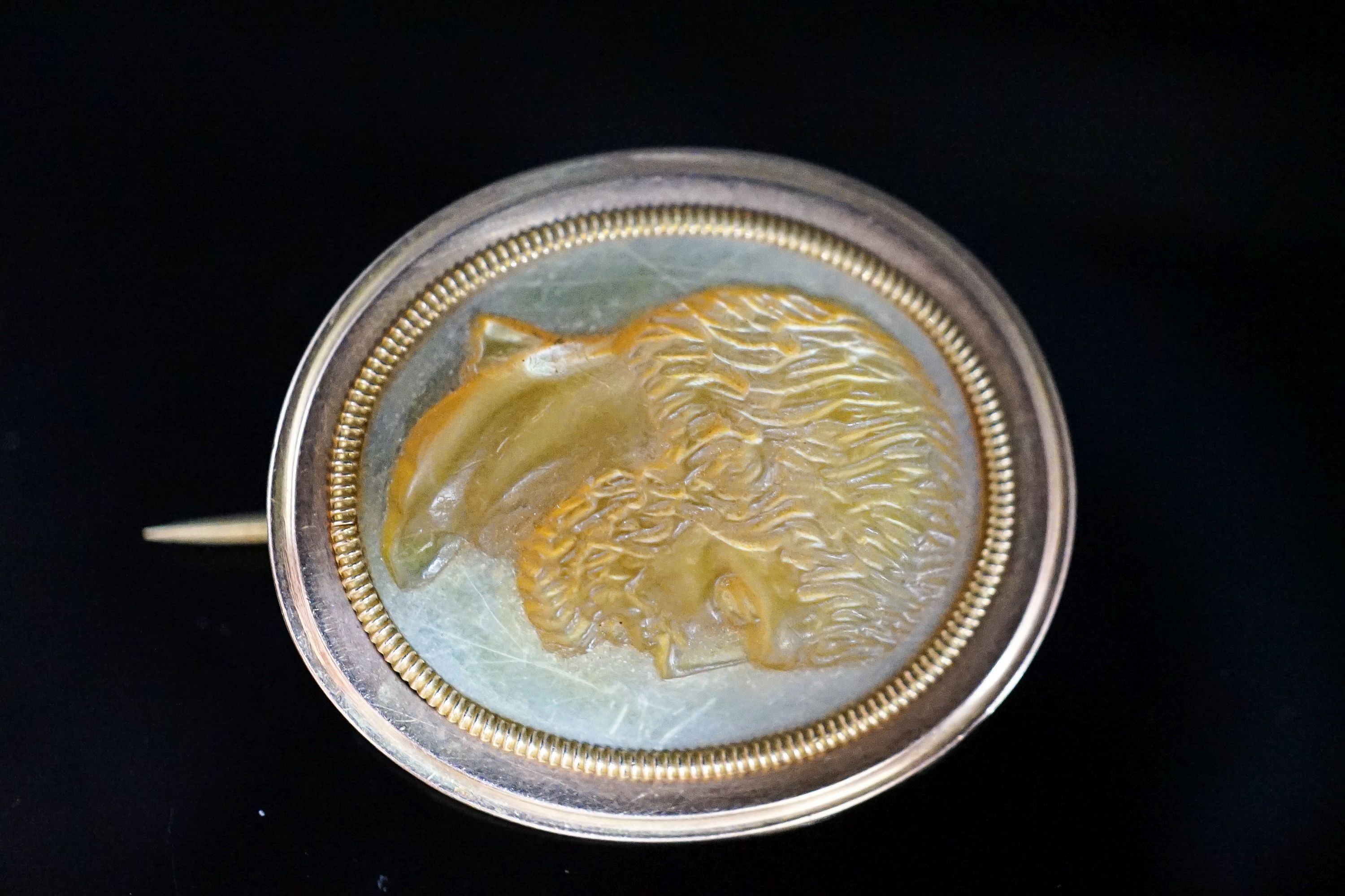 A Regency seed pearl set yellow metal locket and a mother of pearl cameo brooch